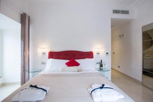 a bedroom with a large bed with two towels on it at San Pietro Grand Suite in Rome
