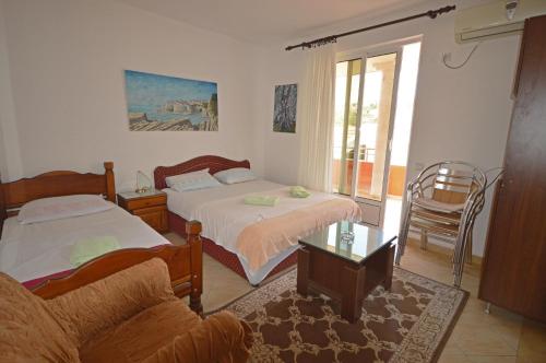 a living room with two beds and a couch at Apartments Djakonovic in Ulcinj