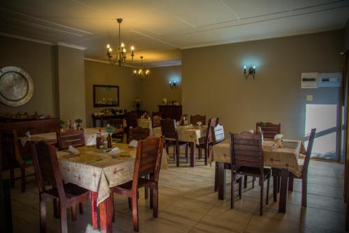 a restaurant with tables and chairs and a dining room at Gariep Country Lodge in Prieska