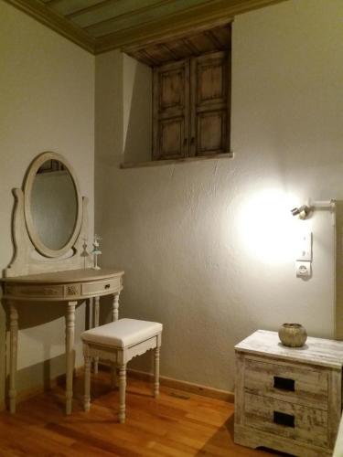 a bathroom with a sink and a mirror and a stool at Lichovo in Papigko
