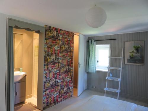 a bathroom with a wall covered in magazines at Chambres d'hôtes - B&B in Gétigné