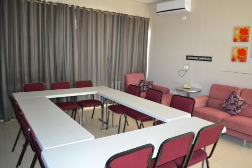 a waiting room with a table and chairs and a couch at Mesami Hotel in Durban