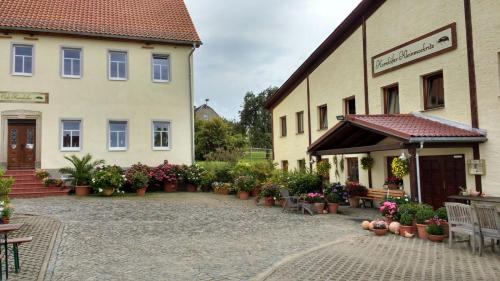 a building with potted plants in front of it at Kornkäfer Kleinmockritz in Döbeln