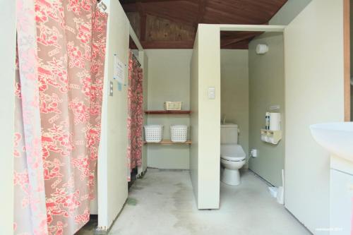 a bathroom with a toilet and a sink at PavilionSurf&Lodge in Shishikui