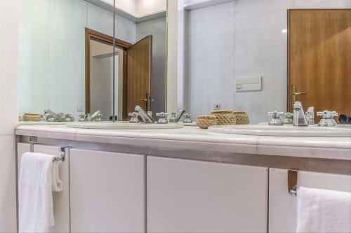 ローマにあるPalazzo Borghese Lovely Flatのバスルーム(シンク2台、大きな鏡付)