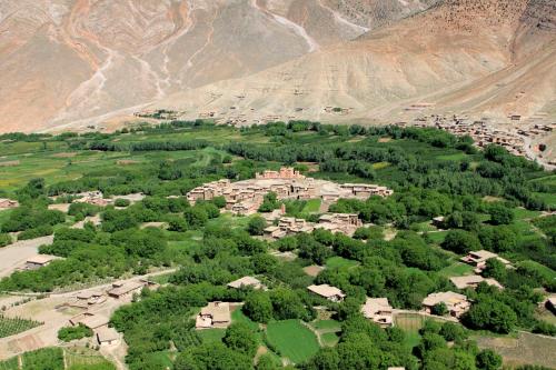 an aerial view of a village in front of a mountain at La Kasbah du M'goun in Timit