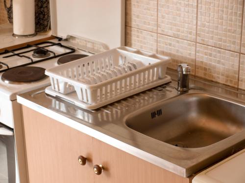 a kitchen counter with a sink and a stove at Apartment Pletikosic in Kaštela