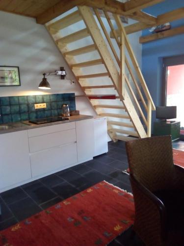 a kitchen with a white counter and a staircase at Bootshaus in Eisenstadt