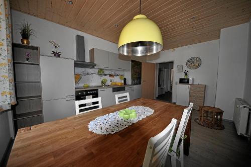 a kitchen and dining room with a wooden table at Apartements Wallner in Hallstatt