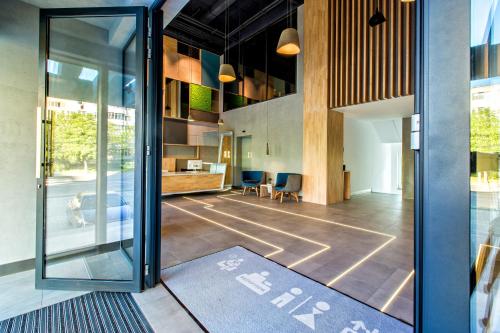 an open lobby with a glass door and a table at Mava Apartamente in Constanţa