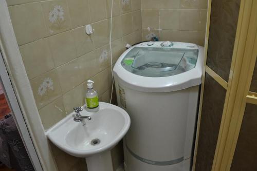 a small bathroom with a toilet and a sink at Studio Copacabana in Rio de Janeiro