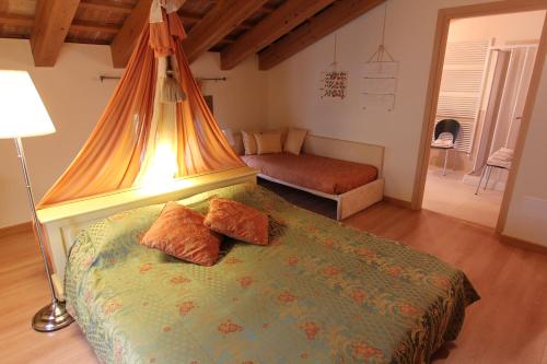 a bedroom with a bed with a canopy at LE TRE ARTI B&B in San Zenone