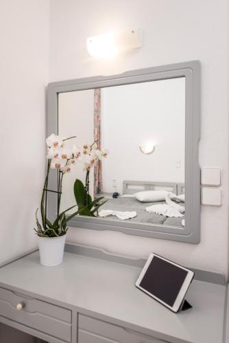a mirror sitting on top of a dresser at Kristall Suites in Stalos