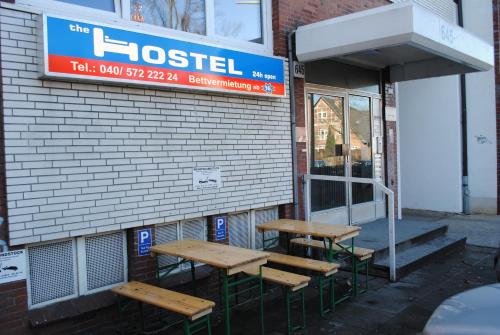 three benches sitting outside of a hostel at The Hostel in Hamburg