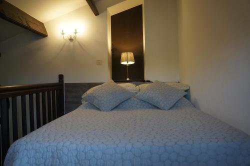 a bedroom with a blue bed with a lamp on it at Lavender Apartment in Argelès-sur-Mer