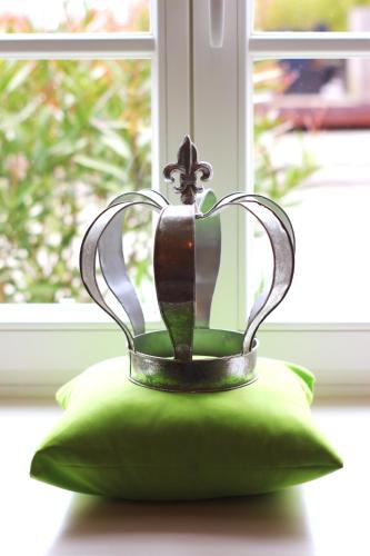a trophy sitting on top of a green pillow at DIE KRONE - Hotel Garni in Kirchzarten