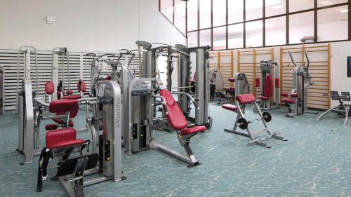 a gym with a bunch of tread machines in it at Eventhotel Pyramide in Vösendorf