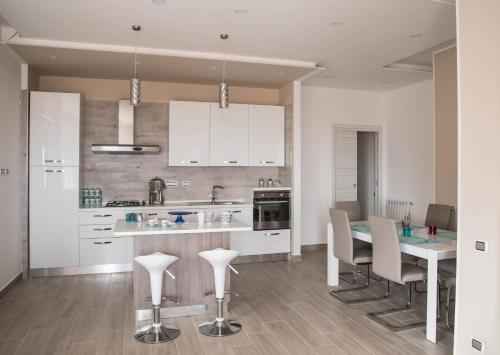 a kitchen with a table and chairs in a kitchen at Damahouse in Formia