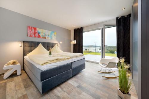 a bedroom with a bed and a large window at Villa Blanca in Binz