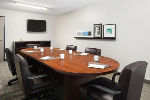 a conference room with a wooden table and chairs at Country Inn & Suites by Radisson, Columbus Airport, OH in Columbus