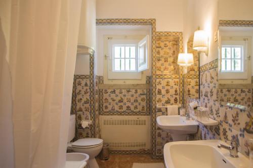 a bathroom with a sink and a toilet and a sink at Quinta de Sao Thiago in Sintra