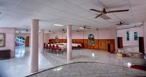 a large room with a table and chairs in it at Banana Bank Lodge & Jungle Horseback Adventures in Belmopan