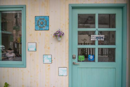a door of a house with signs on it at Mysig in Luodong
