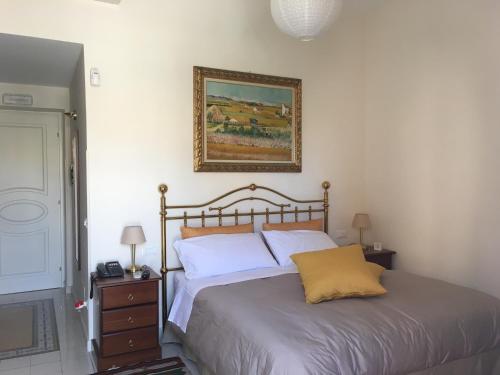 a bedroom with a bed and a picture on the wall at 301B&B in Palermo