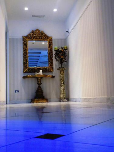 a mirror on a wall with a blue floor at Hotel Residence Villa Del Mare in Rimini