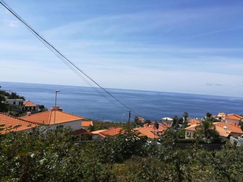 a view of a town with houses and the ocean at Villa Formosa in Funchal