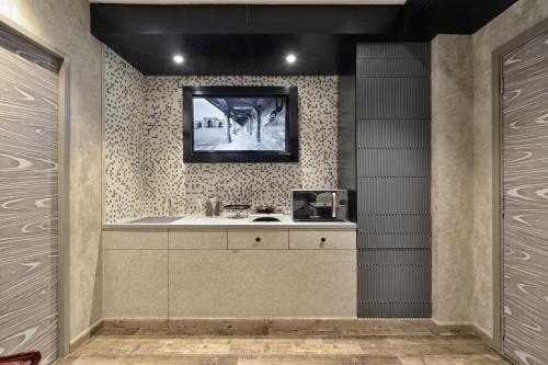a bathroom with a sink and a mirror at Regenta Central Antarim Ahmedabad in Ahmedabad