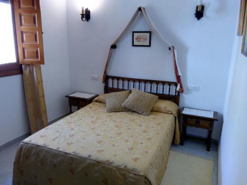 a bedroom with a bed and two night stands at Hostal Meson la Cadena in Trujillo
