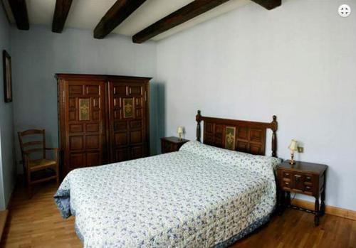 a bedroom with a bed and a table and a chair at Amphore du Berry in Saint-Amand-Montrond