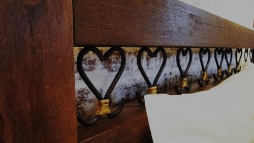 a rack with heart shaped hooks on a wall at Pousada Villa D'Encanto in Monte Verde