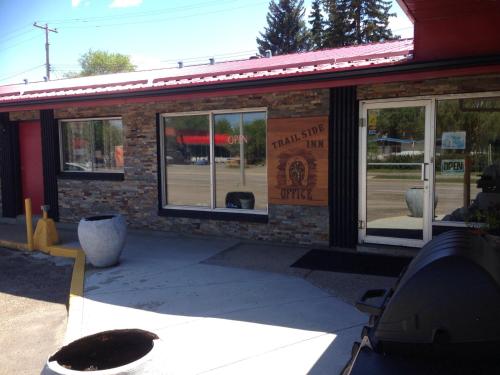 a brick building with windows and a sign on it at Trailside Inn in Lloydminster