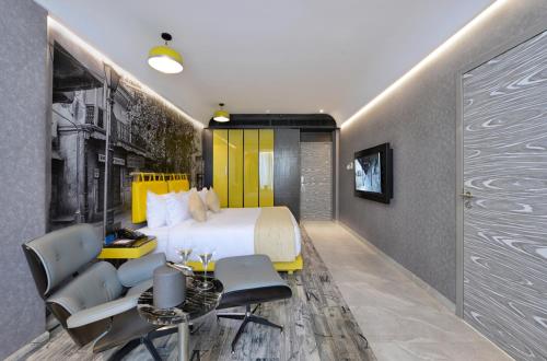 a hotel room with a bed and a table and chairs at Regenta Central Antarim Ahmedabad in Ahmedabad