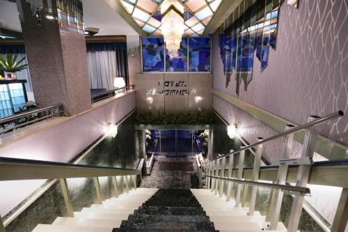 a spiral staircase in a building with a glass ceiling at Xenophon Hotel in Athens