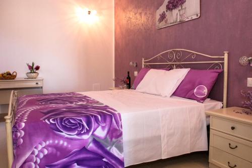 a purple and white bedroom with a bed at Il Sorriso B&B in Ugento