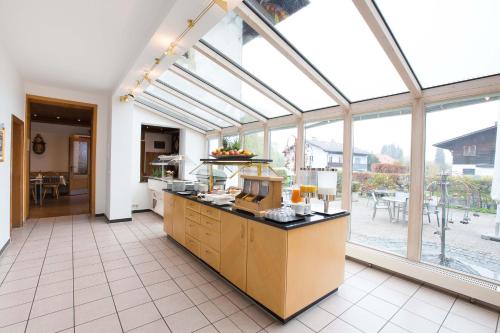 a large kitchen with a large glass ceiling at Hotel am Wald in Bad Tölz