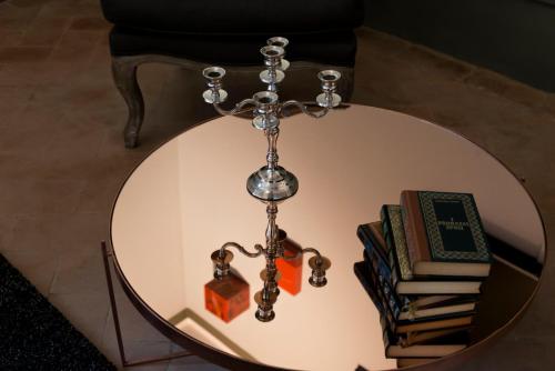 a glass table with a cross and books on it at The Artists' Palace Florence in Florence