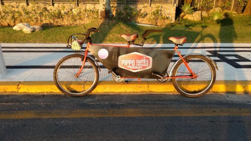 a bike parked on the side of a street at Pippo Suites Guarujá in Guarujá