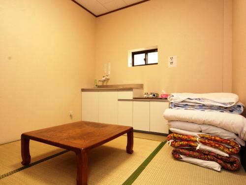 Postel nebo postele na pokoji v ubytování Guesthouse Tomoshibi