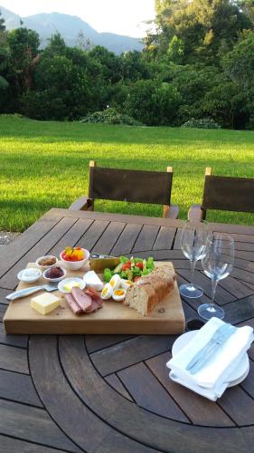 a wooden table with a cutting board with food on it at Patuha Rainforest Retreat in Okato
