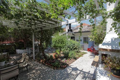a garden with a pergola and some plants at To Spitaki Apartments in Galaxidhion