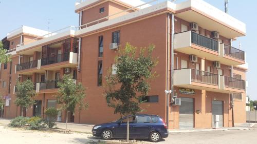 a blue car parked in front of a building at Dimora Artigiani in Foggia