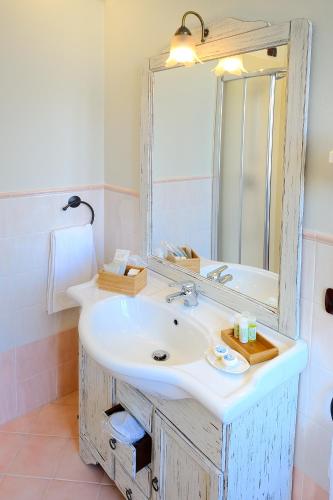 a bathroom with a sink and a mirror at Albergo Giuan Arma di Taggia in Arma di Taggia