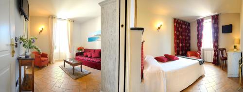 a living room with a bed and a red couch at Albergo Giuan Arma di Taggia in Arma di Taggia