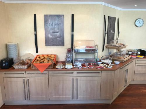 a kitchen with a counter with food on it at Landhaus Bergkrone in Willingen