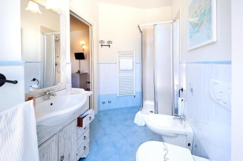 a white bathroom with a sink and a toilet at Albergo Giuan Arma di Taggia in Arma di Taggia