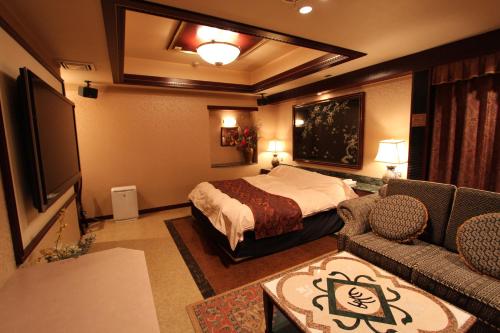 מיטה או מיטות בחדר ב-Hotel LaLa (Adult Only)